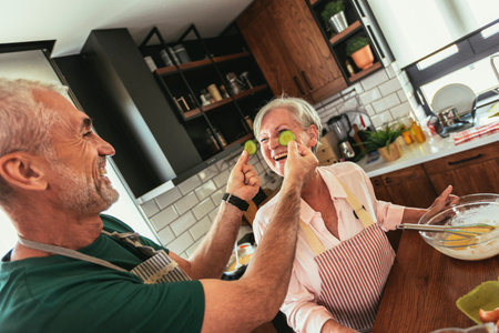 Group of senior friends at dinner party at home, cooking.の写真素材
