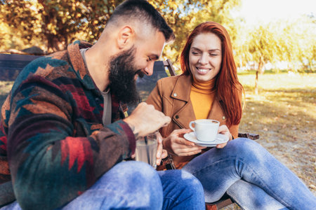 Beautiful loving couple sitting in a cafe enjoying in coffee and conversation.