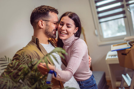 Smiling couple unpacking boxes in new home.New life.They are showing key of their new house.の写真素材