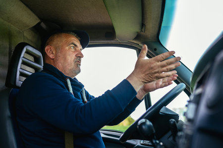 Truck driving arguing with someone on the road.の写真素材
