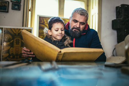 Father and son reading a book together