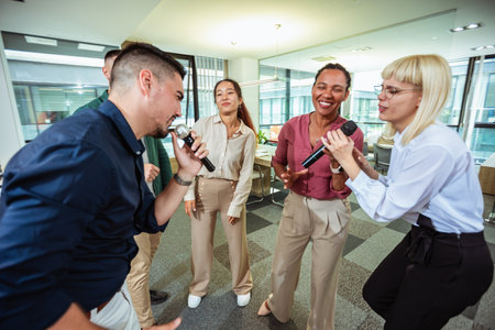 Group of professional people singing karaoke in the modern office
