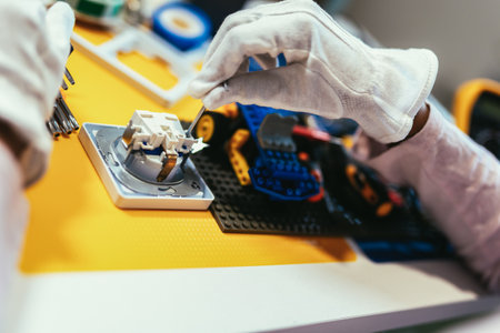 Girl is Working on a Robot in Her Room. Education Concept. Close up.の写真素材