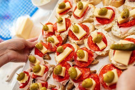 Close up of woman's hand preparing canape.の写真素材