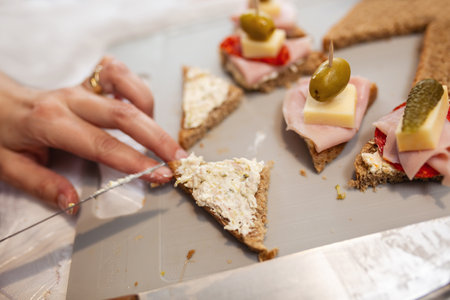 Close up of woman's hand preparing canape.の写真素材