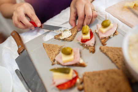 Close up of woman's hand preparing canape.の写真素材