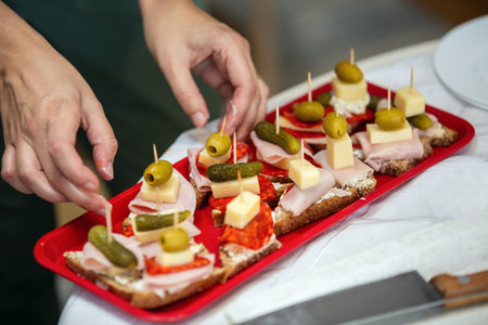 Close up of woman's hand preparing canape.の写真素材