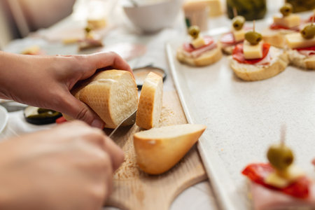 Close up of woman's hand preparing canape.の写真素材