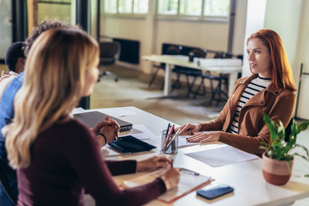 Coworkers talking about serious topics in their office on the jobの写真素材