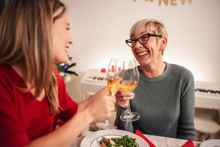 Mother and daughter bonding on family Christmas dinnerの写真素材