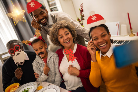Family having good time with fun glasses, hats, mouth..Christmas time.の写真素材