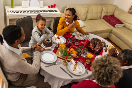 Parents bonding with their daughter on a Christmas Eve dinner.