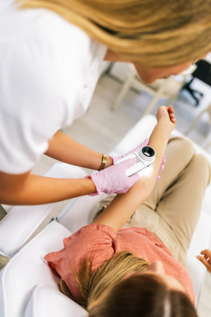 The dermatologist examines the moles or acne of the patient with a dermatoscope. Prevention of...