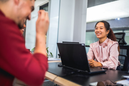 Financial advisor analyzing documents with her clients in a meeting in the office.