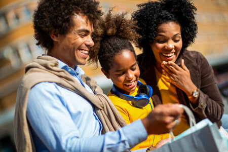 Happy young mixed race couple spending time with their daughter in shopping.の写真素材