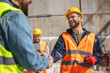 Contractor. construction worker team hands shaking after plan project contract  at construction site, contractor, engineering, partnership, construction conceptの写真素材