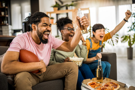 Multiracial group of friends watching rugby.の写真素材