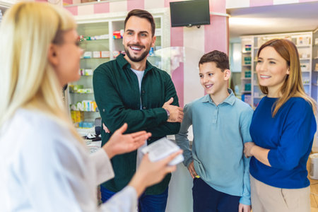 Cheerful pharmacist chemist woman giving vitamins to young family of three in modern pharmacy.の写真素材