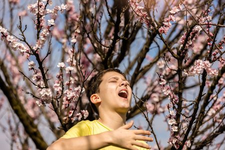 Child with pollen allergy. Boy sneezing because of seasonal allergy.の写真素材
