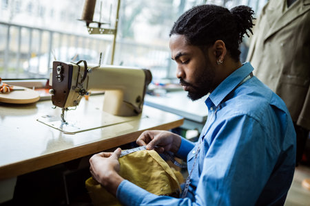 African American men fashion designer,tailor measuring fabric in his atelier.の写真素材