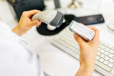 Pharmacist scanning price on a medicine box with barcode reader in pharmacy store.の写真素材