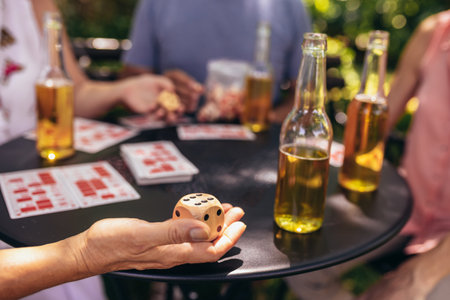 Group of elderly retired people playing bingo outside. Drinking beer and enjoying some time outside.の写真素材