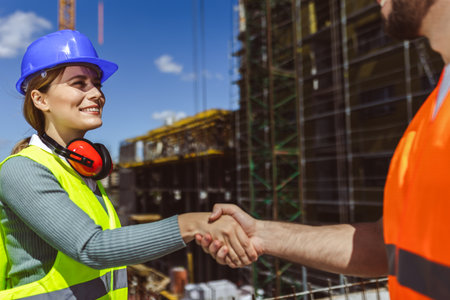Contractor. construction worker team hands shaking after plan project contract  at construction site, contractor, engineering, partnership, construction conceptの写真素材
