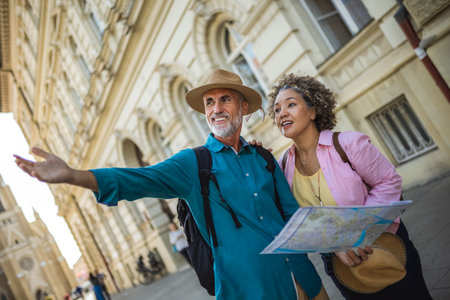 Elderly married couple exploring new city with map. Searching for places.の写真素材
