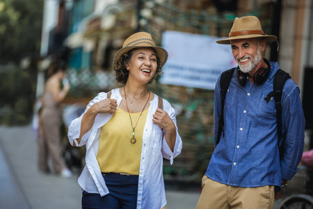 Elderly married couple walking through the new city with backpacks.の写真素材