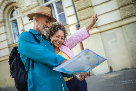 Senior couple exploring new city with map. Searching for places.の写真素材