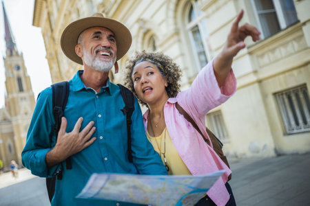 Elderly married couple exploring new city with map. Searching for places.の写真素材