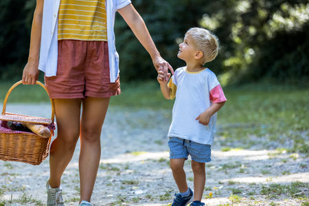 Young mom going on picnic in the park with her son.の写真素材