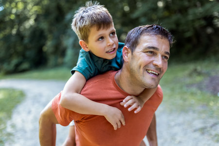 Father playing with his son piggy back.の写真素材