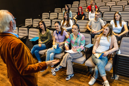 Male elderly professor lecturing students in amphitheater.の写真素材