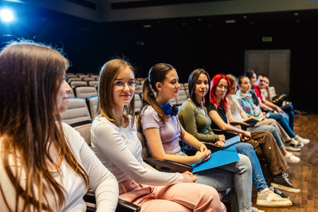 Female student in amphitheater listens to a lecture.の写真素材