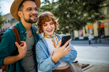 Young couple, on a vacation, exploring the new city and using their phone as gps to help them not get lost.の写真素材