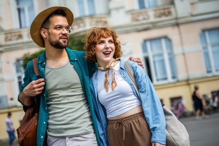 Young couple in love exploring the new city as they are walking and hugging in the city center. Travelling concept.の写真素材