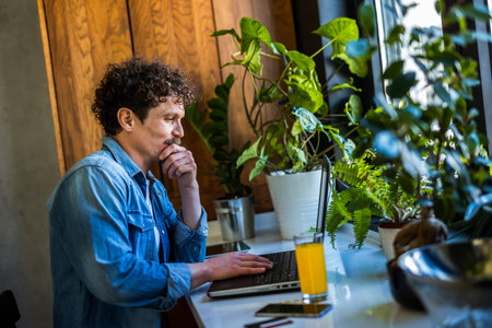 Latino man working from home on his computer.の写真素材