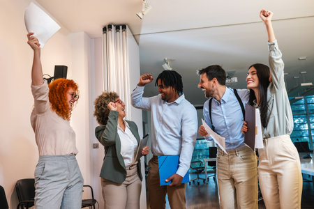 Portrait of multiracial business people. Celebrating their success. Throwing papers and smiling.の写真素材