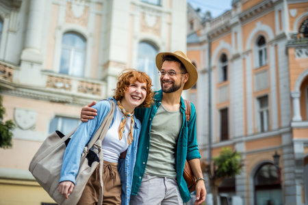 Young couple in love exploring the new city as they are walking and hugging in the city center. Travelling concept.の写真素材