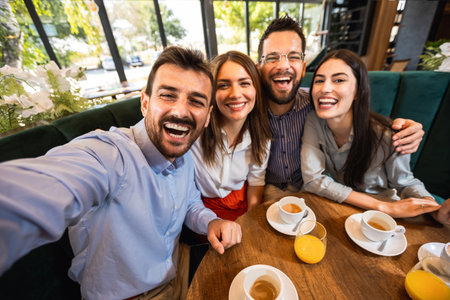 Group of friends at the restaurant taking selfie to capture the moment.の写真素材