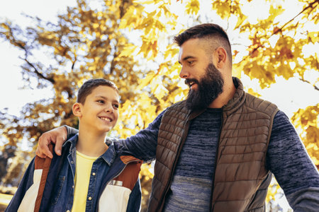 Dad and son bonding in the colorful park. Autumn day.の写真素材