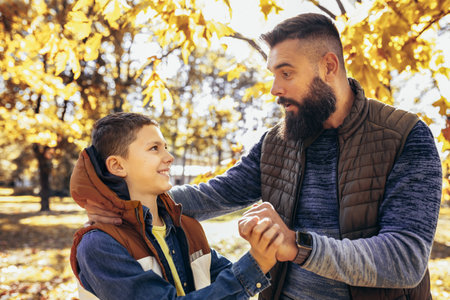 Dad and son bonding in the colorful park. Autumn day.の写真素材