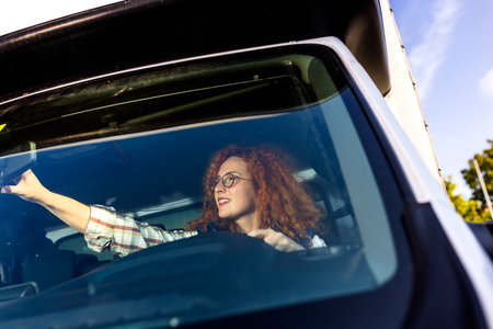 Woman truck driver arguing with people on the road in her truck.の写真素材