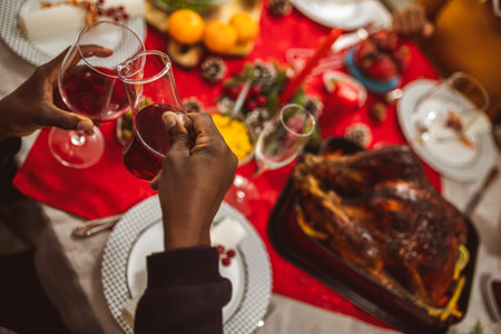 African American family drinking wine at the Thanksgiving, Christmas dinner.の写真素材