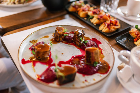Tasty sliced roast meat  with cranberry sauce on a plate. Food and drink concept.の写真素材