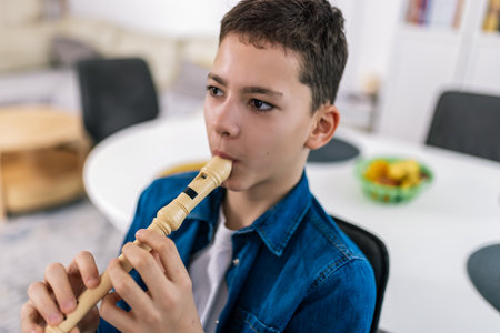 Boy plays flute at home.の写真素材