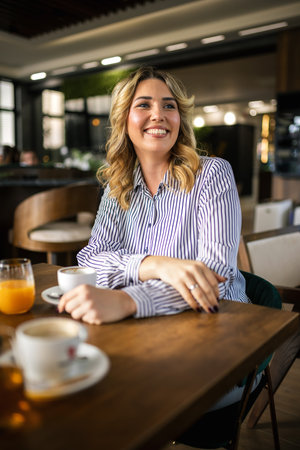 Portrait of beautiful woman drinking coffee in a restaurant.の写真素材
