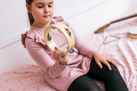 Little girl playing tambourine.の写真素材