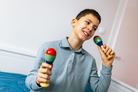 Boy plays rattle at home.の写真素材